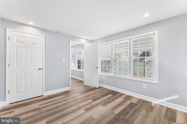 spare room with wood-type flooring