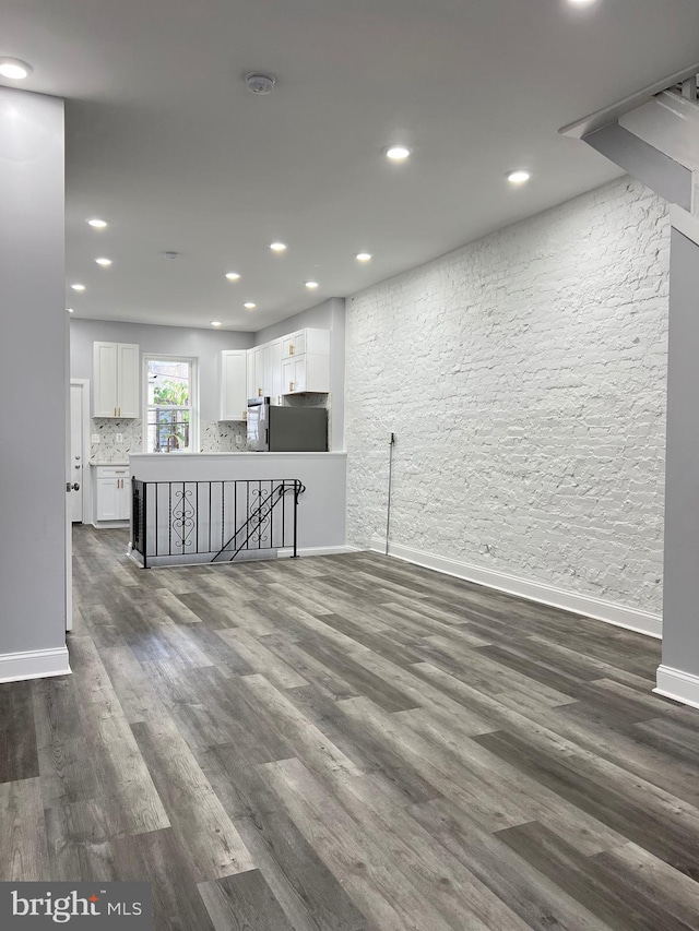 unfurnished living room with dark hardwood / wood-style floors