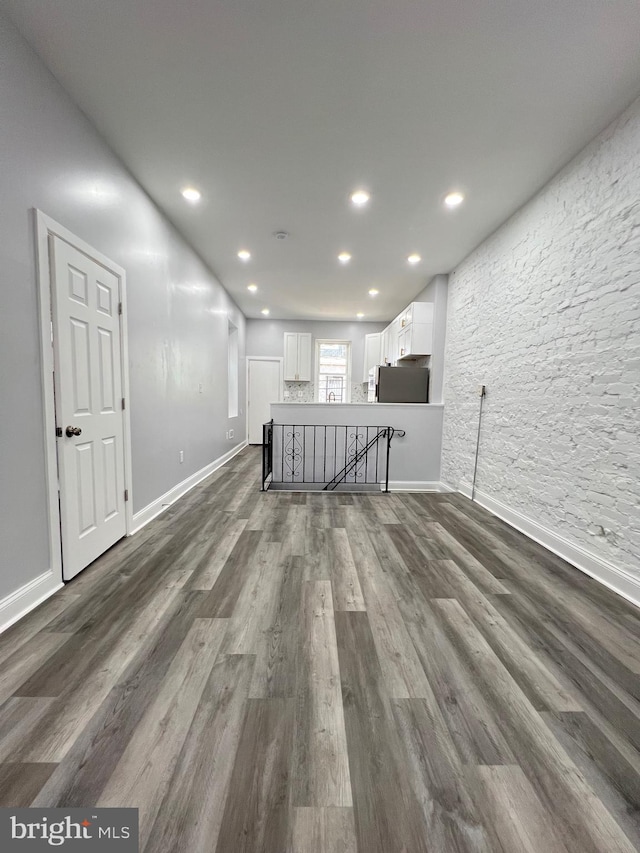 unfurnished living room featuring dark hardwood / wood-style floors