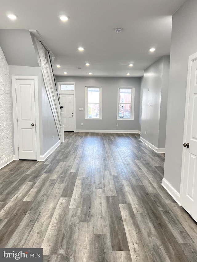 unfurnished living room featuring dark hardwood / wood-style floors