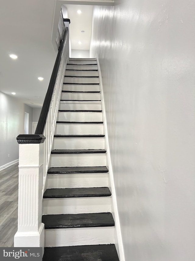 stairway featuring hardwood / wood-style floors