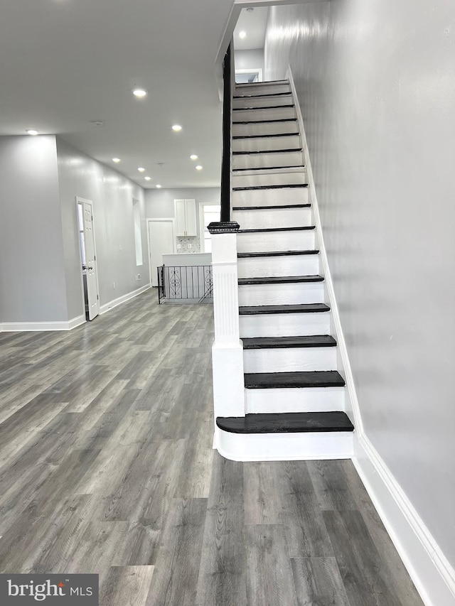 stairway featuring hardwood / wood-style flooring