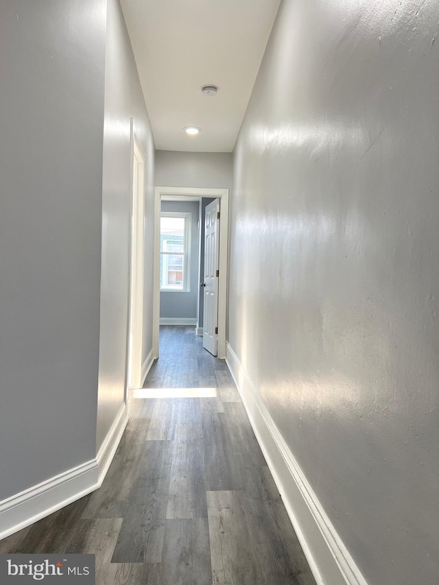 hallway with hardwood / wood-style floors