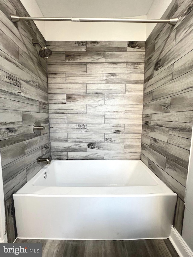 bathroom featuring tiled shower / bath and hardwood / wood-style flooring