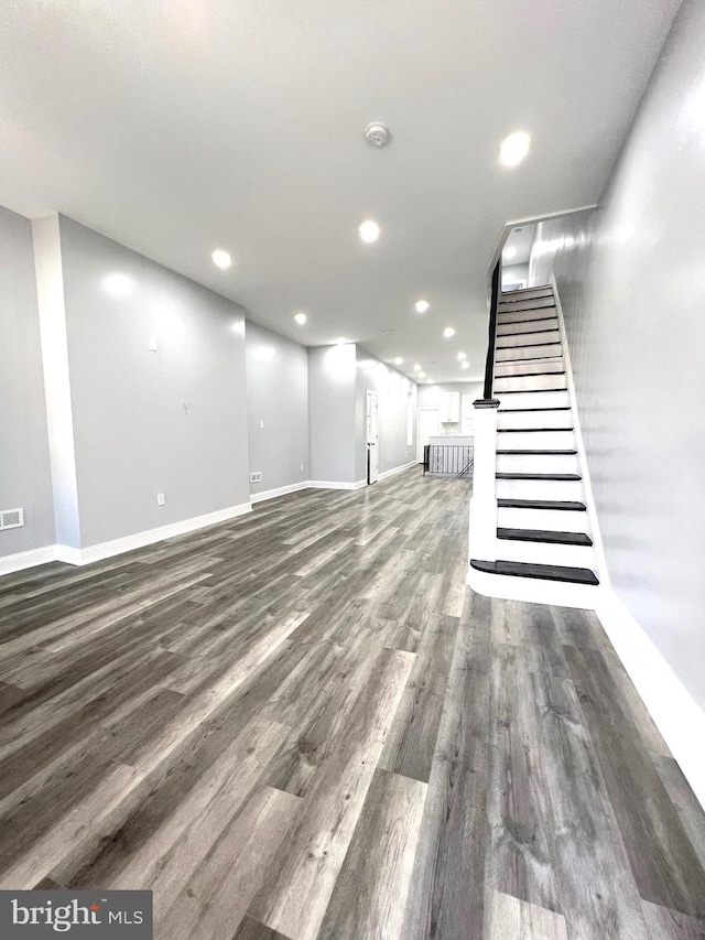 unfurnished living room with dark hardwood / wood-style flooring