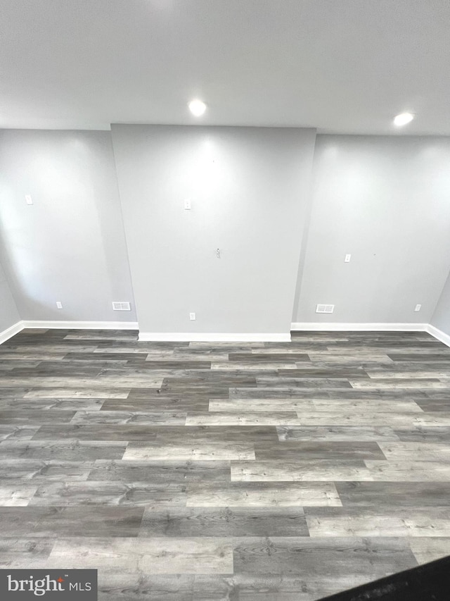 basement with dark hardwood / wood-style floors