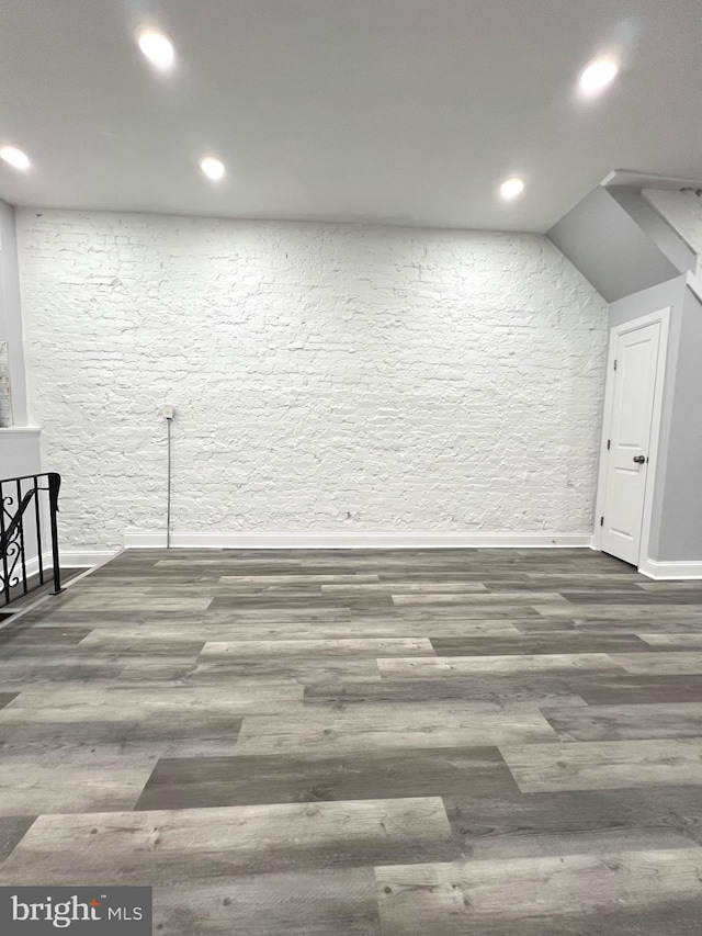 interior space featuring vaulted ceiling and dark hardwood / wood-style flooring