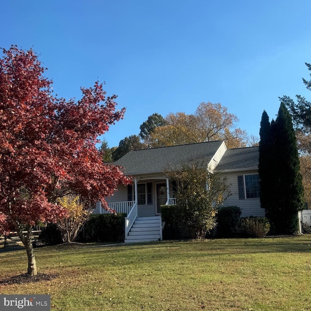 view of front of house with covered porch and a front yard