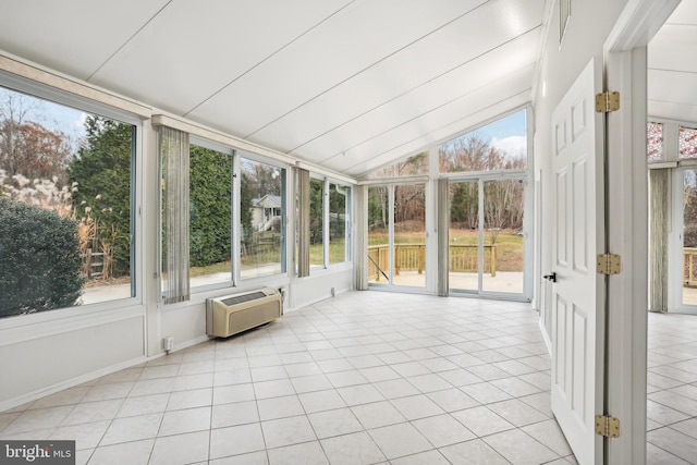 unfurnished sunroom featuring vaulted ceiling and an AC wall unit