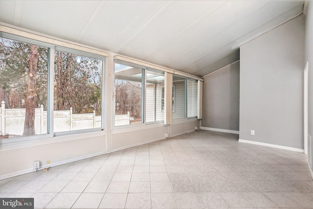 unfurnished sunroom featuring lofted ceiling