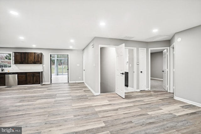 unfurnished living room featuring light hardwood / wood-style flooring and a healthy amount of sunlight