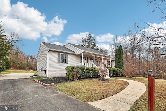 view of front of property with covered porch and a front yard