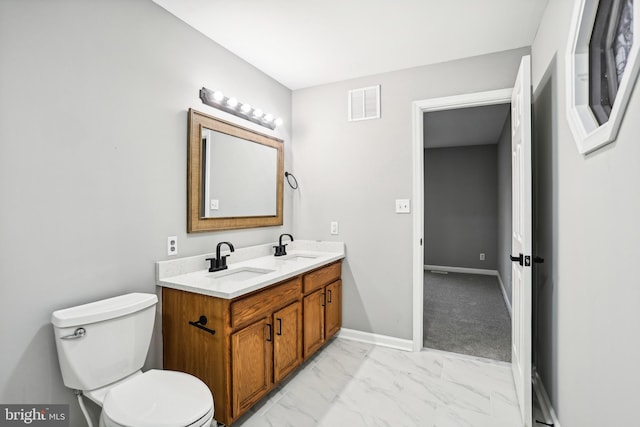 bathroom featuring vanity and toilet