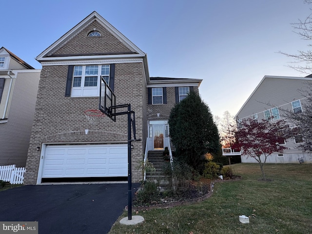 view of front of home featuring a garage and a lawn