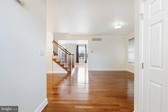 interior space with hardwood / wood-style flooring and ornamental molding