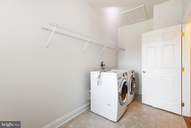 clothes washing area with washing machine and dryer