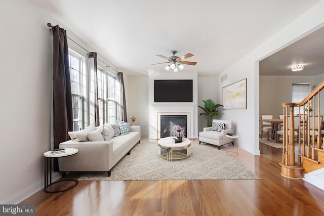 living room featuring ceiling fan and wood-type flooring