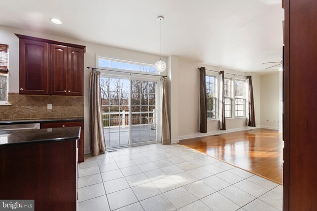 interior space featuring decorative backsplash, ceiling fan, light hardwood / wood-style floors, and decorative light fixtures