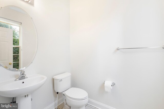 bathroom with tile patterned flooring, toilet, and sink