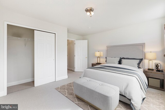 bedroom featuring light carpet and a closet