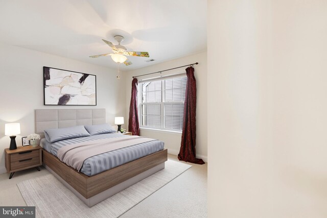 bedroom featuring light colored carpet and ceiling fan