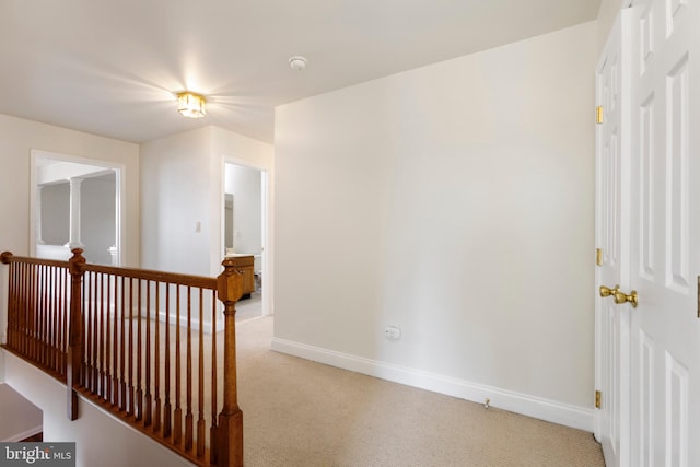 hall featuring light colored carpet