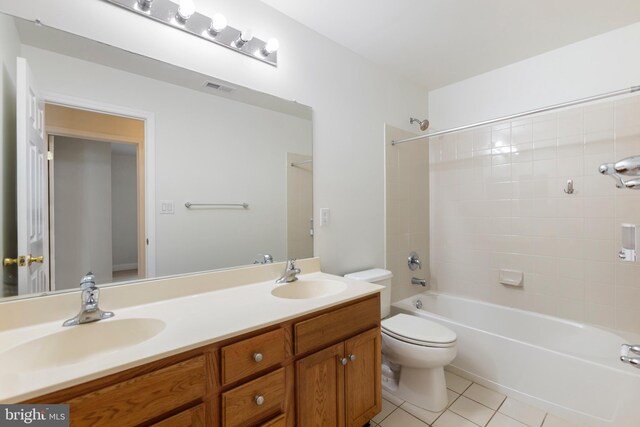 full bathroom with toilet, vanity, tile patterned floors, and tiled shower / bath