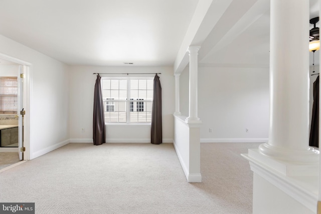 unfurnished living room featuring light carpet