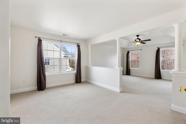 carpeted spare room featuring ceiling fan and a healthy amount of sunlight