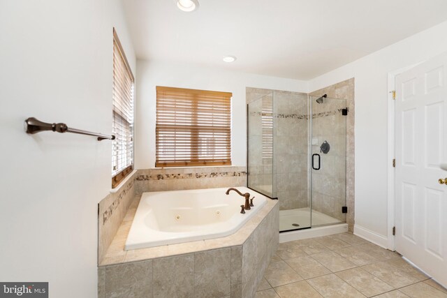 bathroom featuring tile patterned flooring and separate shower and tub