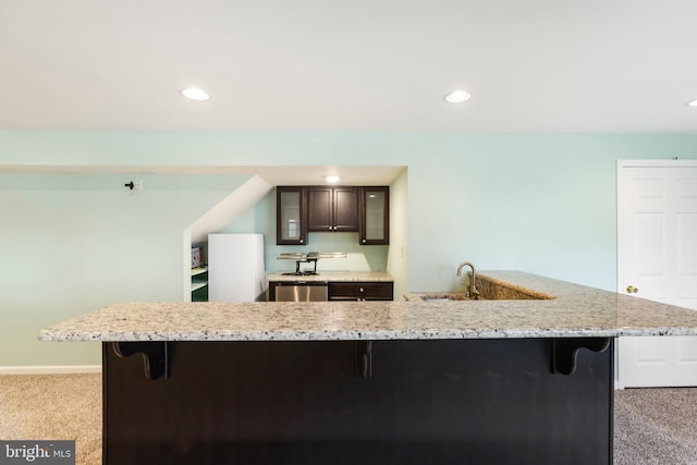 kitchen with a kitchen breakfast bar, white refrigerator, and light carpet