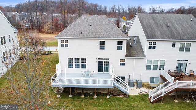 rear view of property featuring a deck and central air condition unit