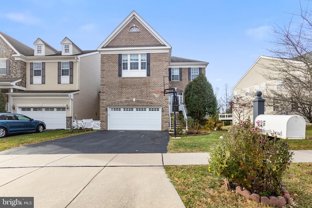 view of front of home with a garage and a front lawn