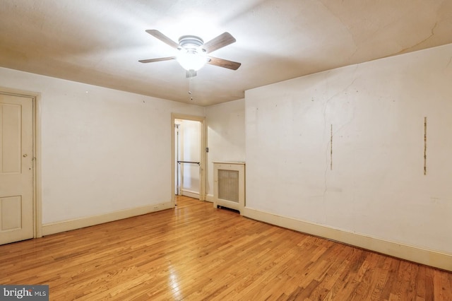 empty room with light hardwood / wood-style flooring and ceiling fan