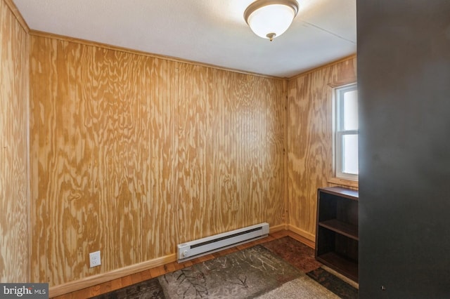 unfurnished room featuring dark hardwood / wood-style floors, a baseboard heating unit, and wood walls