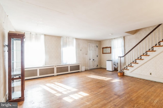 entrance foyer with wood-type flooring and radiator