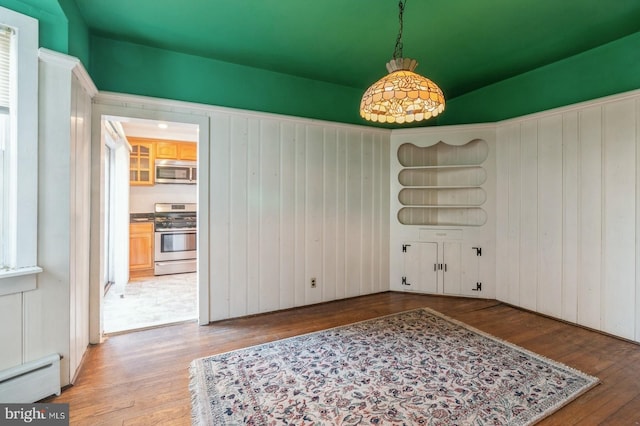 dining room with wood-type flooring and baseboard heating