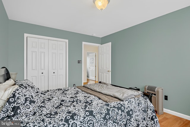 bedroom featuring a closet and light wood-type flooring