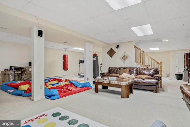 recreation room with a drop ceiling and carpet floors