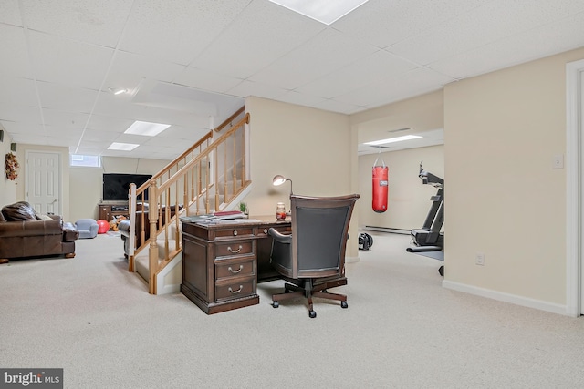 home office with a drop ceiling, a baseboard heating unit, and light carpet