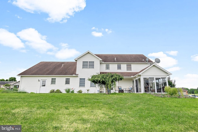 rear view of house with a patio area and a lawn