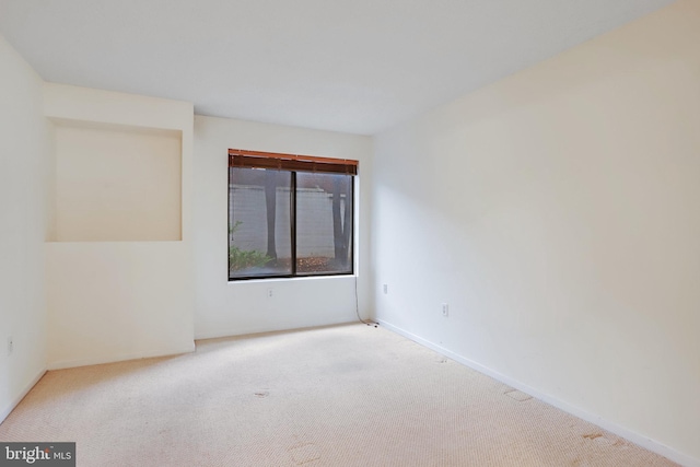 unfurnished room with light carpet