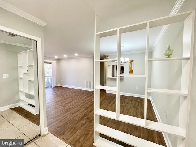 interior space with wood-type flooring and crown molding