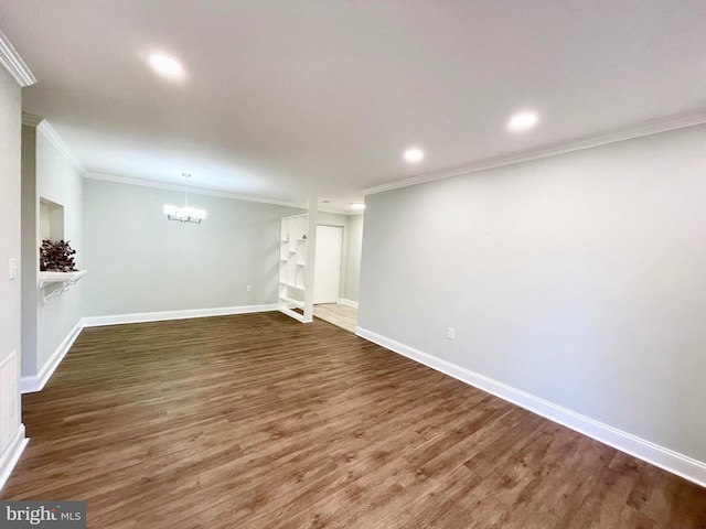 basement with ornamental molding and dark hardwood / wood-style floors