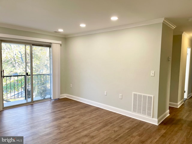 empty room with crown molding and dark hardwood / wood-style flooring