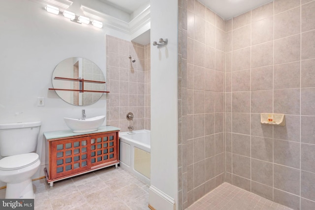 bathroom with toilet, vanity, and tiled shower / bath combo