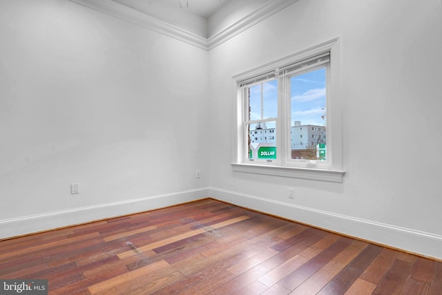unfurnished room featuring baseboards and hardwood / wood-style flooring