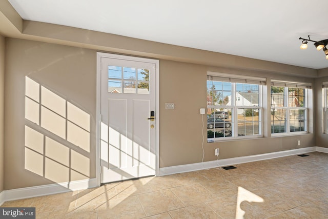 tiled foyer entrance featuring a wealth of natural light