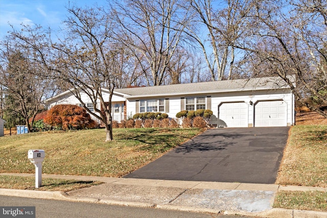 single story home featuring a garage and a front lawn