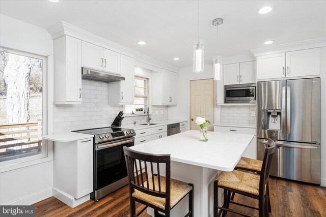 kitchen with plenty of natural light, sink, white cabinetry, and stainless steel appliances